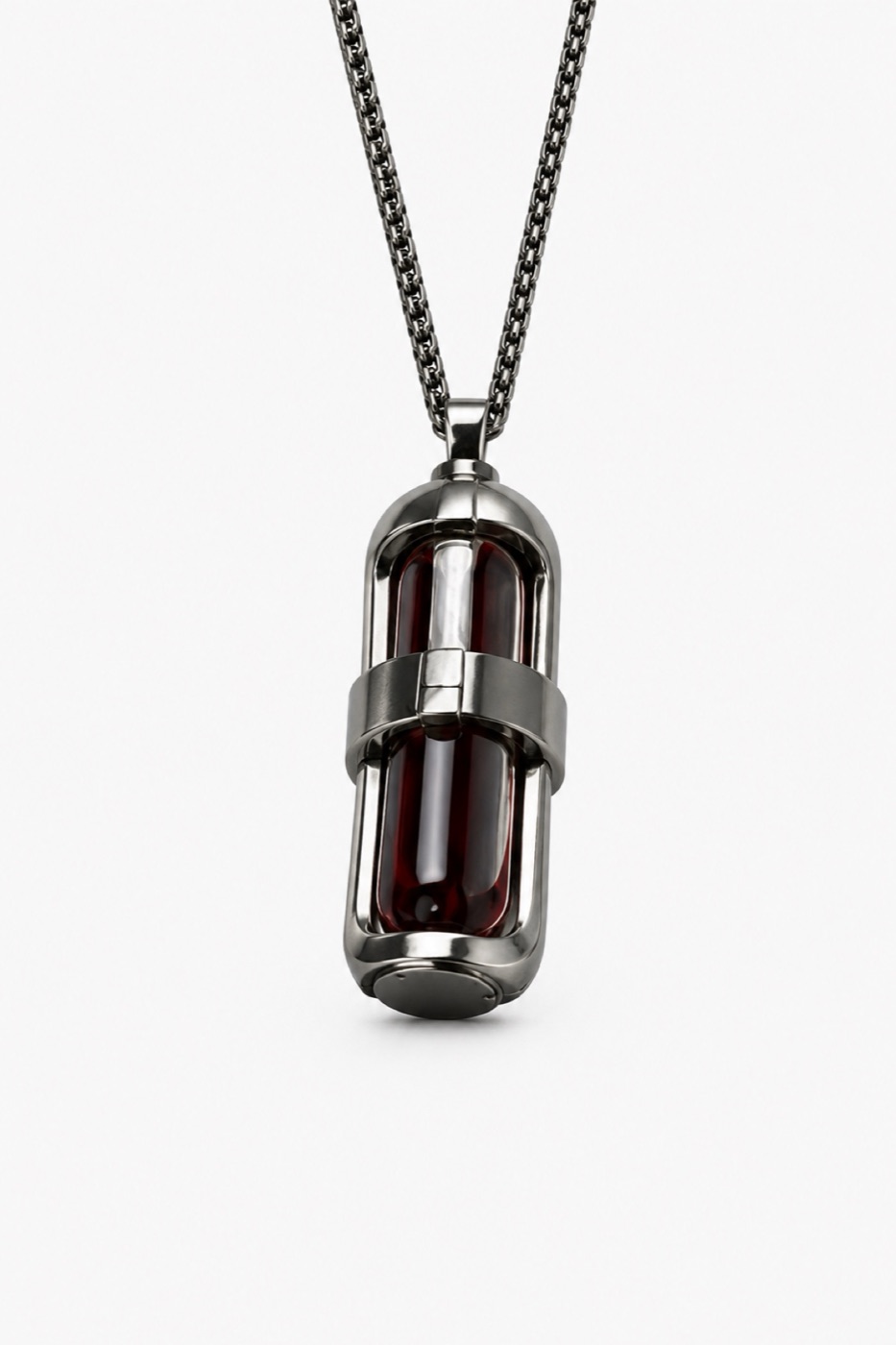 Red capsule pendant in a sculptural cage